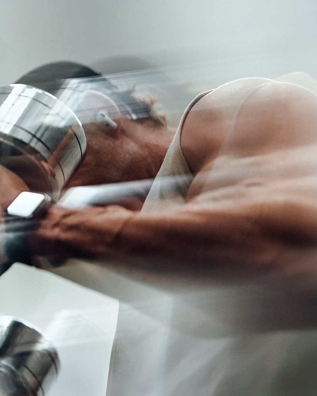 Athlete pressing a barbell overhead in a gym